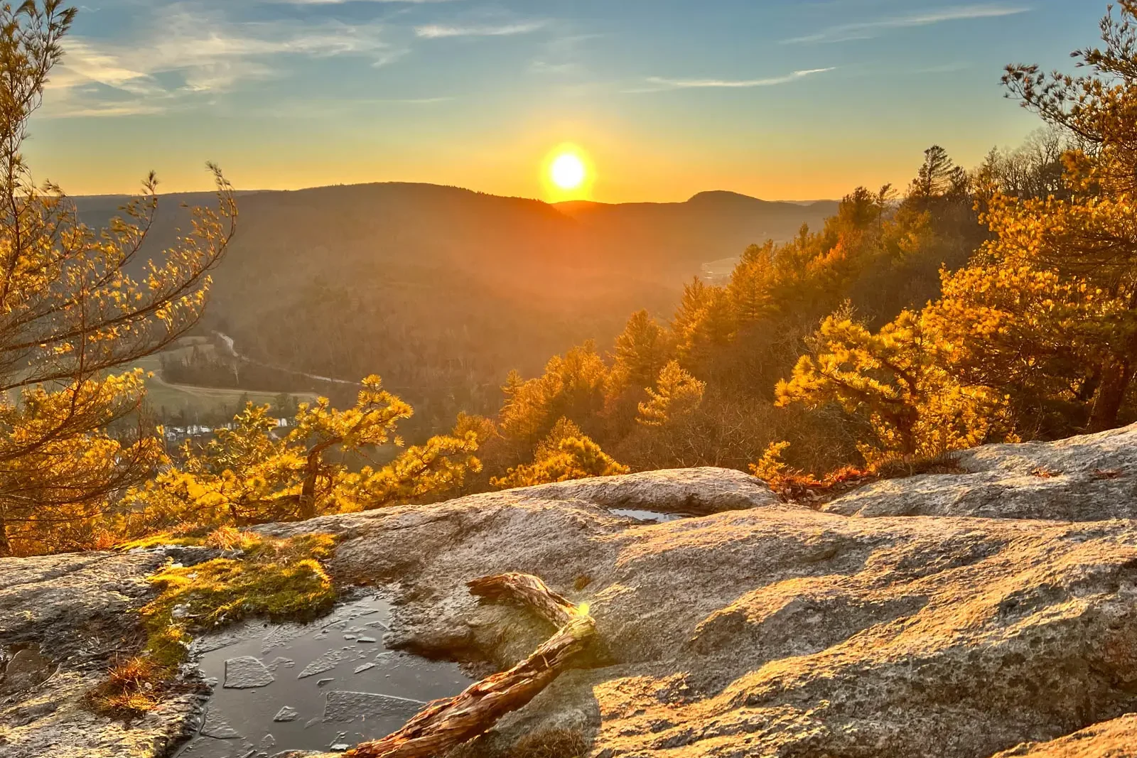golden sun setting at top of hike in connecticut.