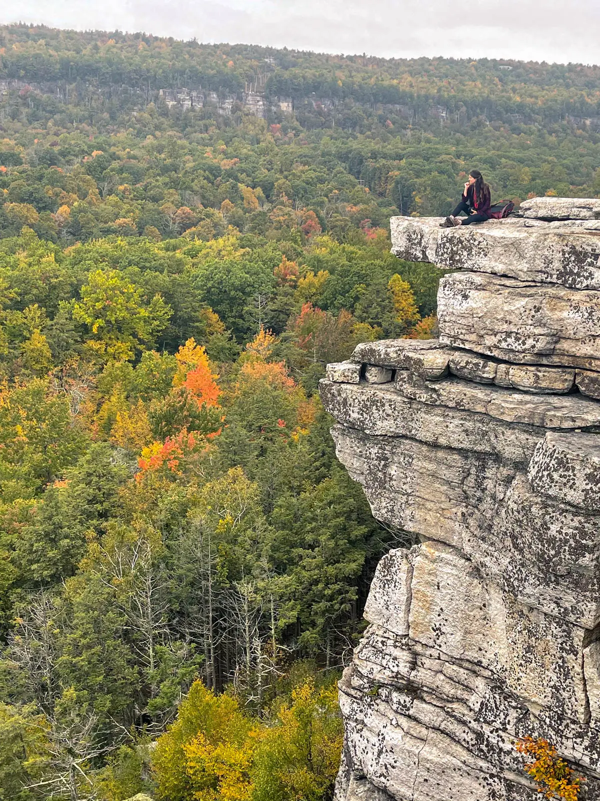 woman on cliff edge at minnewaska state park in new york.