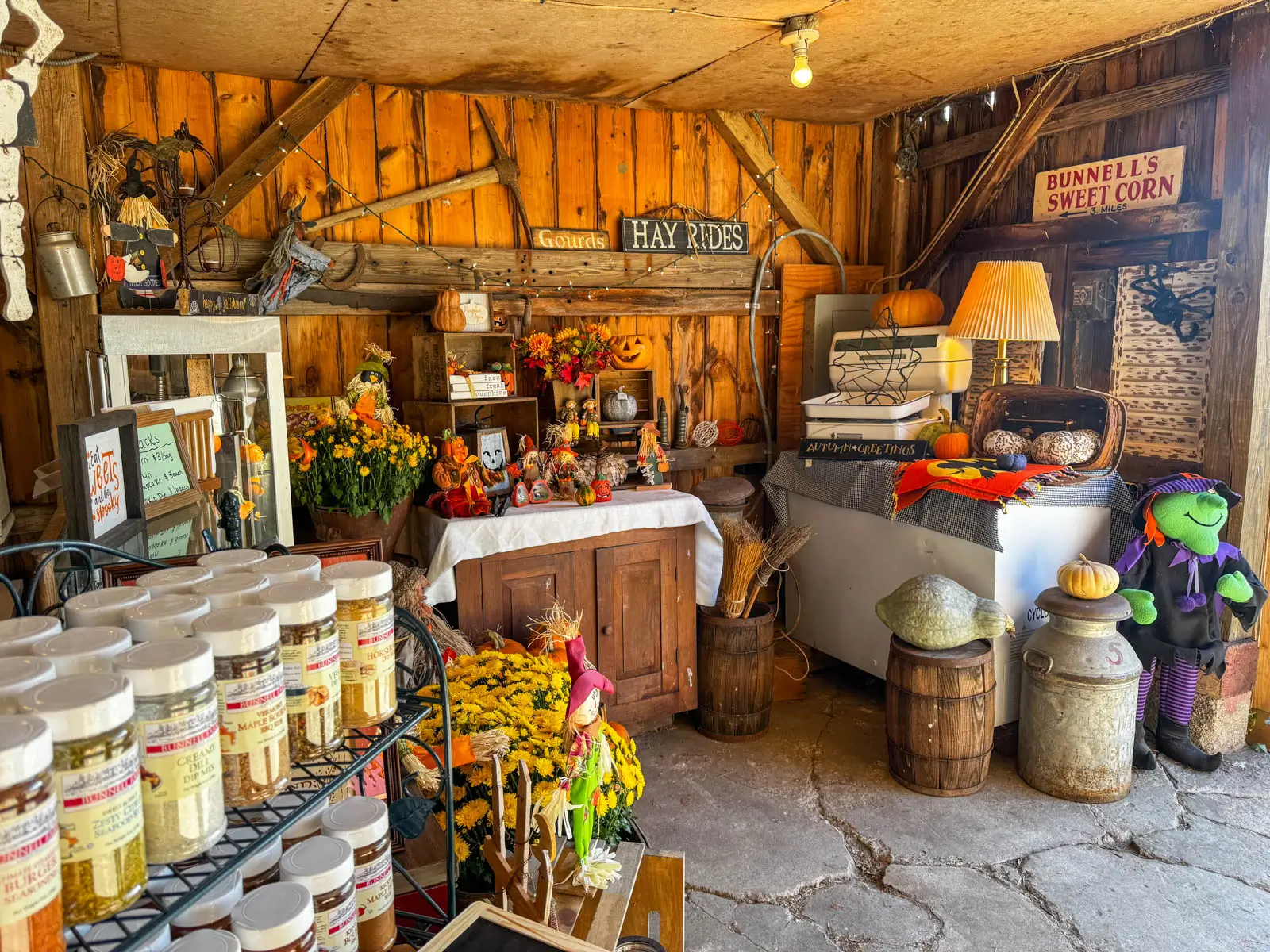 inside bunnell farm with fall decor and racks of spices and fall knick knacks and decorations to buy.