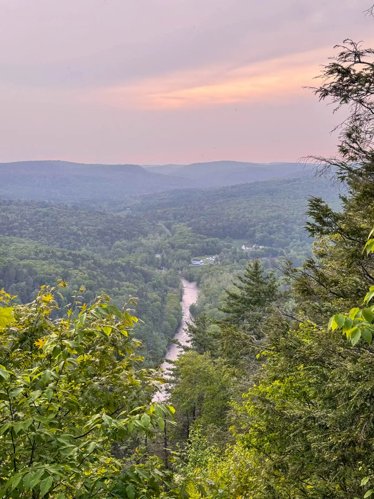 view from hike in connecticut with river running through a green hilly valley.