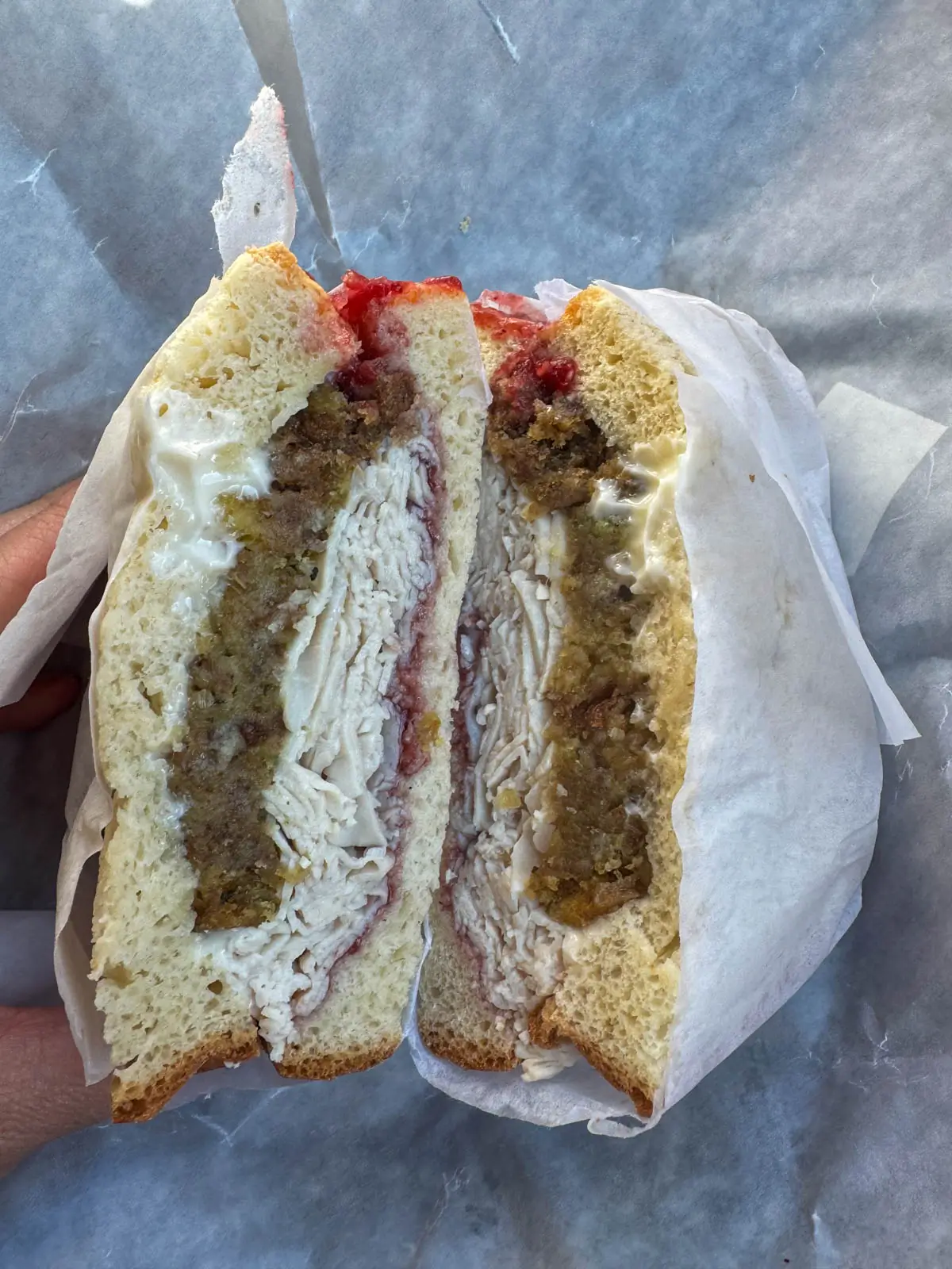 an open sandwich stacked with turkey, cranberry mayo, and a layer of stuffing on a fall day in vermont.