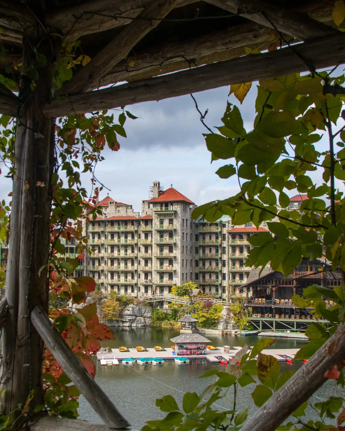 view of mohonk house an intricate hotel in new paltz with tall uneven buildings and lots of windows.